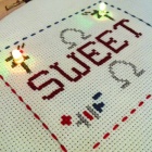 Cross stitch made with conductive thread